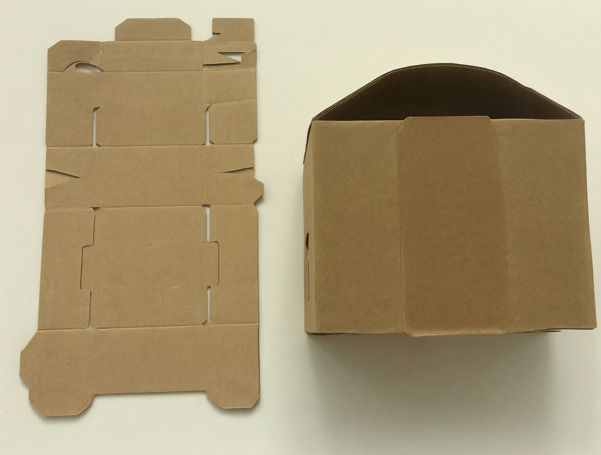 Close-up of cardboard boxes showing the flat-pack design and folded assembly.