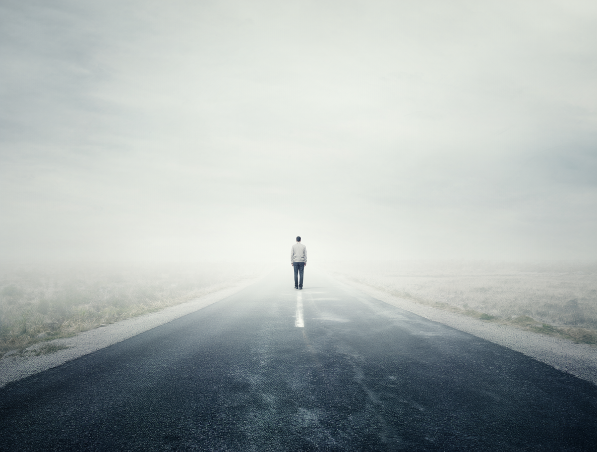 Solitary figure at a fork in the road representing personal growth
