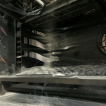 Gaming PC tower on a metal stand with airflow streams visible