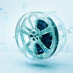 Digital workspace showing film reel transforming into digital file with code snippets.