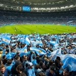 Multitudes entusiastas en un estadio de fútbol con banderas argentinas