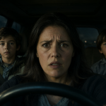 Mujer y dos niños dentro de un automóvil al atardecer