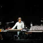 Jean Michel Jarre tocando en un gran escenario con sintetizadores vintage durante los conciertos en China.